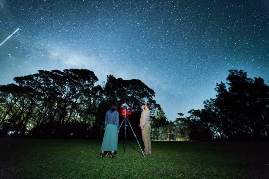 Jervis Bay Stargazing guides Dimitri and Caroline with a telescope in Plantation Point Park