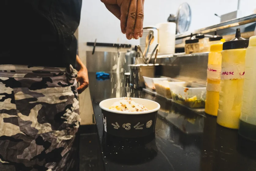 Chef adds the finishing touches to a bowl of pasta at Pasta Buoy in Huskisson