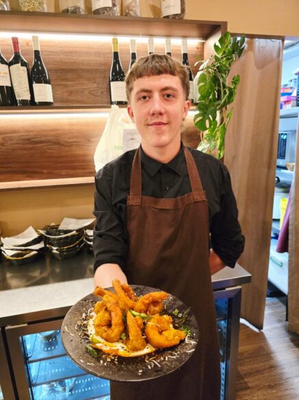 Rylan Bracken shows off the Malabar prawns at Taj Indian Restaurant in Huskisson. Photo Narrell Tabone