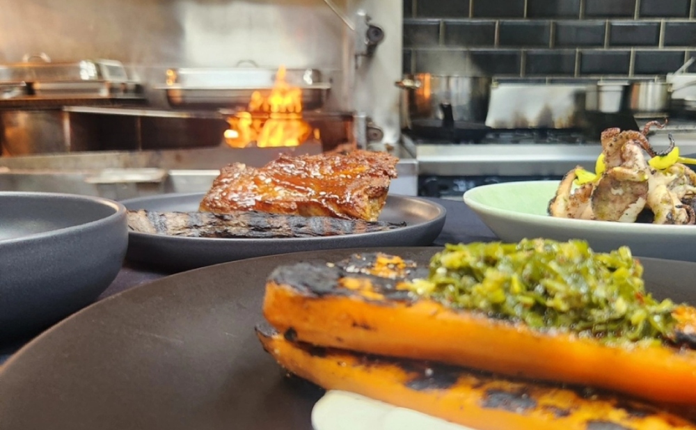 Dine at Old Salt Distillery in South Nowra, where the chefs prepare over an open flame. Photo via Facebook