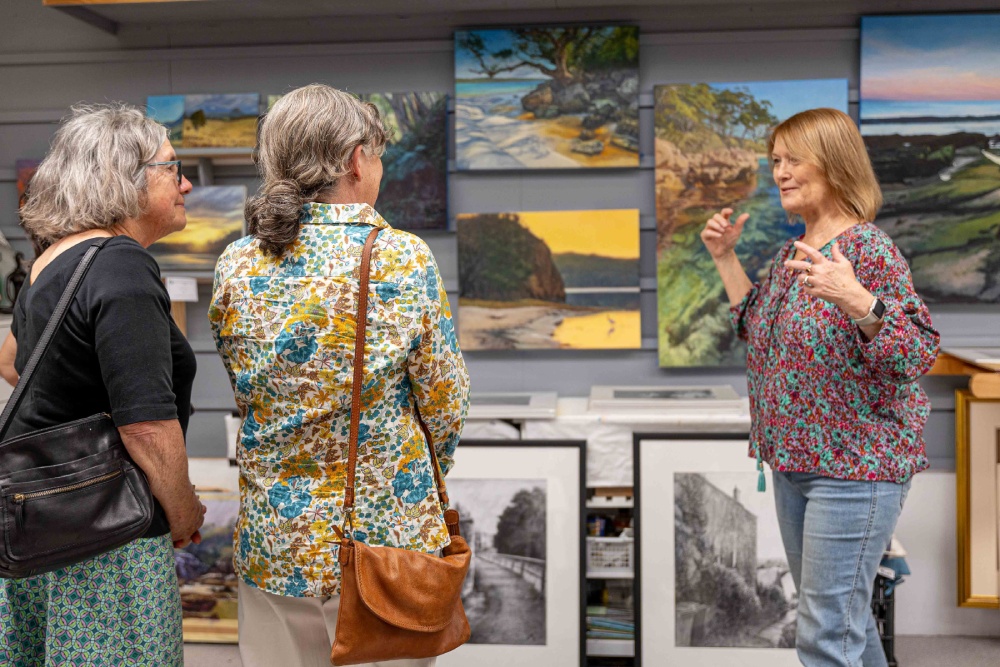 Jenny McIntosh showing visitors around her studio on the Jervis Bay Arts Trail. Photo: Tania Genoves