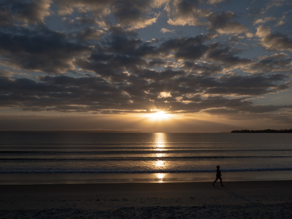 A sunrise walker on Nelson Beach, Vincentia, Jervis Bay. Photo: U+