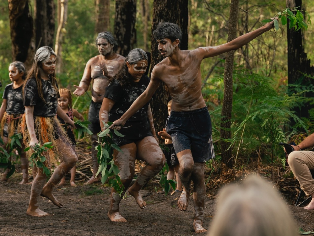 First Nations cultural custodians Gadhungal Marring will conduct ceremonies, dances and stories on Monday 26 January at Moona Moona Creek Reserve. Image via Facebook