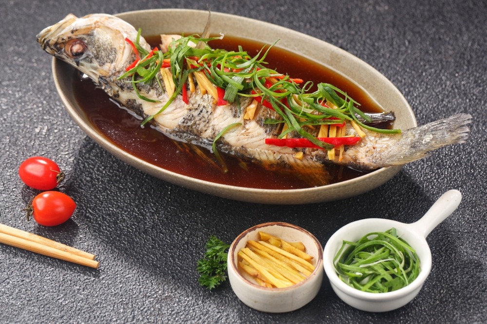 Nose-to-tail dining in the Year of the Fire Horse includes whole steamed fish at James Kitchen Huskisson. Adobe Stock image
