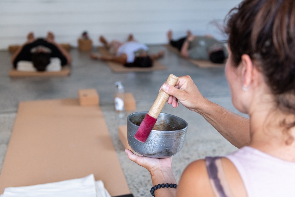 Wellness modalities in Jervis Bay, woman practising with a meditation bowl at Bay & Bush