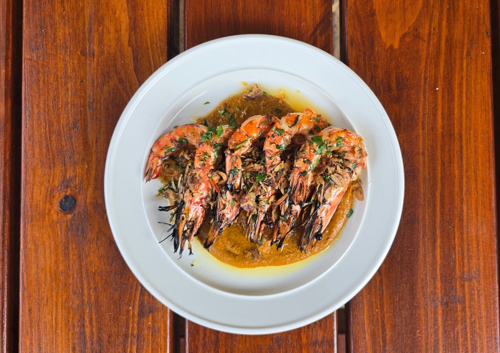Five char-grilled tandoori tiger prawns with yogurt sauce and fresh lemon at Bud’s Tavern. Photo Narrell Tabone