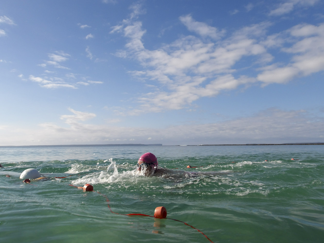 The winner crosses the line in a friendly race between Wobbegong winter swimmers. Photo Seana Smith.