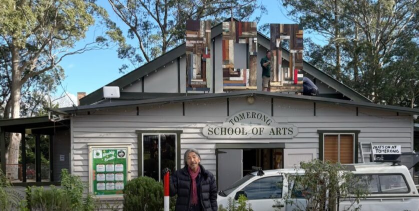 Sculptor and local resident Akira Kamada with his installation to celebrate the centenary of Tomerong Hall.