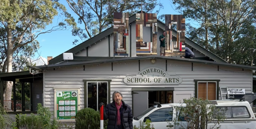 Sculptor and local resident Akira Kamada with his installation to celebrate the centenary of Tomerong Hall.